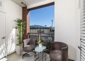 Thumbnail 11 of 27 - a patio with two chairs and a table at Areum Apartment, California, 91016