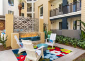 Thumbnail 14 of 27 - a patio with two chairs and a fire place in front of an apartment building at Areum Apartment, Monrovia  