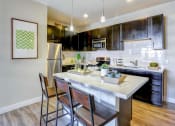 Thumbnail 22 of 25 - a kitchen with a large center island next to a stove top oven