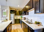Thumbnail 15 of 25 - a kitchen with a sink and a refrigerator
