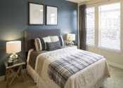 Thumbnail 8 of 25 - a bedroom with a bed and two windows