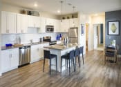 Thumbnail 13 of 25 - a kitchen with a center island next to a stove top oven