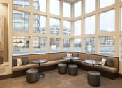 Thumbnail 18 of 25 - a large window with a row of tables and benches in front of it