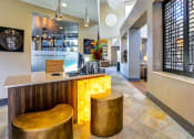 Thumbnail 12 of 25 - a hotel lobby with a bar and stools