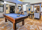 Thumbnail 10 of 25 - a large living room with a pool table in the middle of it