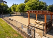 Thumbnail 36 of 47 - a dog park with a fenced in area and a bench