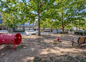 Thumbnail 6 of 40 - A red fire hydrant sits in the middle of a dirt field.