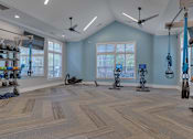 Thumbnail 19 of 40 - A spacious room with exercise equipment and a large window.