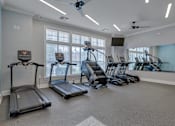 Thumbnail 24 of 40 - A spacious room with treadmills and elliptical machines.