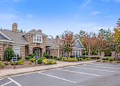Thumbnail 16 of 40 - A building with a parking lot in front of it.