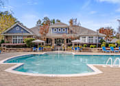 Thumbnail 11 of 40 - A large house with a pool in the backyard.