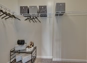 Thumbnail 39 of 40 - A room with a shelf, hangers, and shoes.