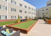 Thumbnail 28 of 28 - our apartments showcase an outdoor living area with a bocce court
