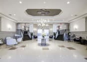 Thumbnail 17 of 28 - a lobby with a table and chairs and a chandelier