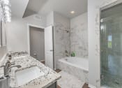 Thumbnail 5 of 41 - A bathroom with a marble countertop and a walk-in shower and soaking tub at Barton Creek Villas, Austin, TX