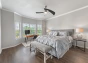 Thumbnail 9 of 41 - A bedroom with a bed, a chair, and a table with a lamp on it at Barton Creek Villas, Austin.