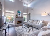 Thumbnail 4 of 41 - A modern living room with a grey couch, a fireplace, and a glass coffee table. at Barton Creek Villas, Texas, 78735