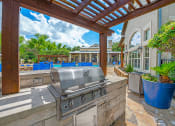 Thumbnail 15 of 41 - A patio with a grill and a pool table. at Barton Creek Villas, Austin, TX