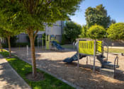Thumbnail 34 of 47 - a playground with a yellow bench and a blue slide