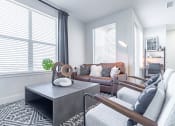 Thumbnail 5 of 30 - a living room with a leather couch and a coffee table at RockVue, Broomfield, Colorado