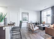 Thumbnail 7 of 30 - a living and dining area with white walls and hardwood flooring at RockVue, Broomfield