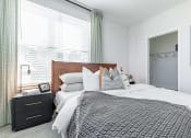 Thumbnail 16 of 30 - a bedroom with a bed and a dresser with a mirror at RockVue, Broomfield, Colorado