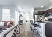 Thumbnail 8 of 30 - a kitchen and living room at RockVue, Broomfield