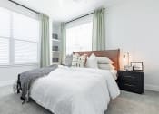 Thumbnail 15 of 30 - a bedroom with two windows and a bed with a white comforter and pillows at RockVue, Broomfield, 80021