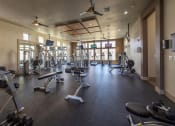 Thumbnail 12 of 28 - a large fitness room with weights and other exercise equipment at Retreat at Shadow Creek Ranch Apartments, Woodburn