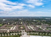 Thumbnail 3 of 28 - an aerial view of a large city with houses and trees at Retreat at Shadow Creek Ranch Apartments, Woodburn, 77584