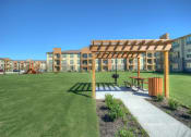 Thumbnail 28 of 28 - a pergola seating area at Retreat at Shadow Creek Ranch Apartments, Texas, 77584