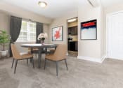 Thumbnail 2 of 12 - a dining room with a table and chairs at Parkland Village, Forestville, MD 20747
