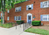 Thumbnail 11 of 12 - a brick building with a blue door at Parkland Village, Maryland, 20747