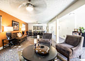 Thumbnail 16 of 24 - a living room with couches and chairs and a table at Eagles Landing Apartments, Everett, WA