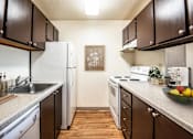 Thumbnail 4 of 24 - full kitchen with white appliances and wood flooring at the preserve at Eagles Landing Apartments, Everett, WA