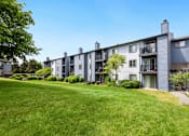 Thumbnail 23 of 24 - exterior view of apartment buildings on a sunny day at Eagles Landing Apartments, Everett, 98204