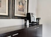 Thumbnail 18 of 24 - a coffee maker sitting on top of a cabinet in a hotel room at Eagles Landing Apartments, Everett, 98204