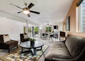 Thumbnail 13 of 24 - a living room with couches and chairs and a table at Eagles Landing Apartments, Everett, 98204