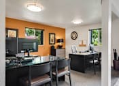 Thumbnail 17 of 24 - a dining room with a glass table and chairs and a desk with a computer at Eagles Landing Apartments, Everett, WA