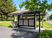 Thumbnail 20 of 24 - a bus stop with a shelter on the side of a road at Eagles Landing Apartments, Everett, WA