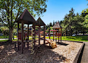 Thumbnail 21 of 24 - a playground with a swing set and other play equipment at Eagles Landing Apartments, Everett, 98204
