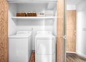Thumbnail 8 of 24 - a small laundry room with two washes and a dryer at Eagles Landing Apartments, Everett, 98204