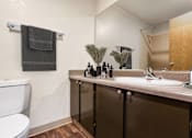 Thumbnail 9 of 24 - a bathroom with a sink toilet and a mirror at Eagles Landing Apartments, Everett, WA 98204