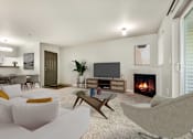 Thumbnail 13 of 22 - a living room with a couch and a chair and a television and a fireplace at Sage Apartments, Washington, 98204