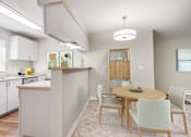 Thumbnail 17 of 22 - a dining room and kitchen with a table and chairs at Sage Apartments, Everett, Washington