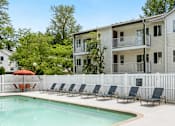 Thumbnail 4 of 22 - a swimming pool with chairs in front of a house at Sage Apartments, Washington