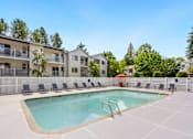 Thumbnail 3 of 22 - our apartments have a resort style pool with chairs at Sage Apartments, Everett