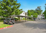 Thumbnail 12 of 22 - a parking lot with a jeep parked in front of a house at Sage Apartments, Everett, Washington