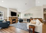 Thumbnail 6 of 22 - a living room with a fireplace and a couch at Sage Apartments, Everett