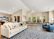 Thumbnail 7 of 22 - a living room with a white couch and a blue chair at Sage Apartments, Everett, 98204